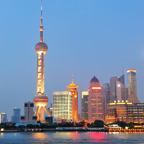 Urban skyscrapers in Shanghai at night over river